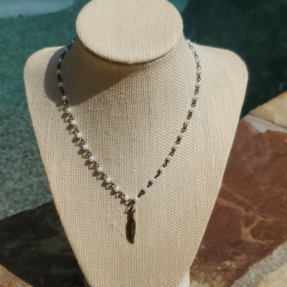 Pearl beaded and bronze chain with feather charm.